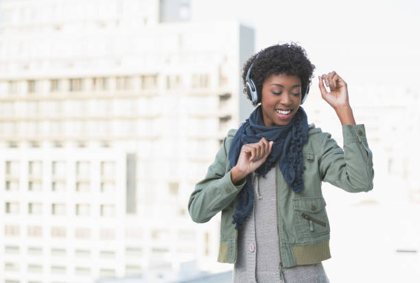 istock Smiling casual model dancing while listening to music 835746190