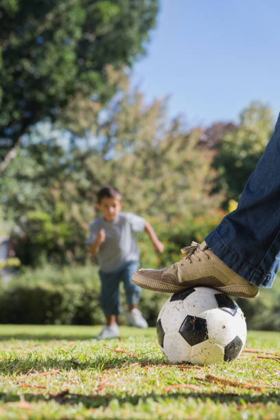 istock Boy running towards the football 835746346
