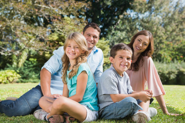 istock Young family sitting in a park 835746600
