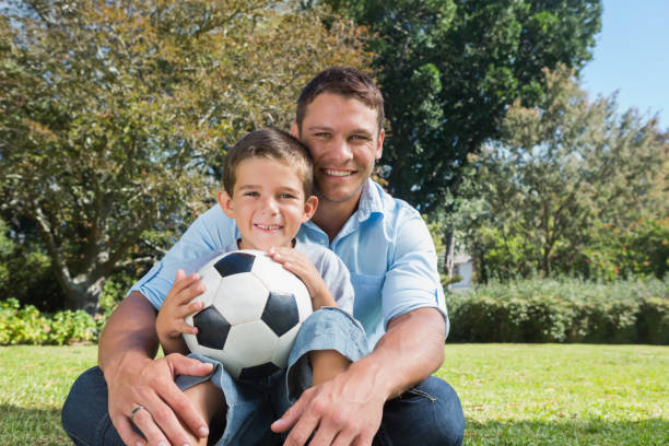 istock Smiling dad and son in a park 835746650