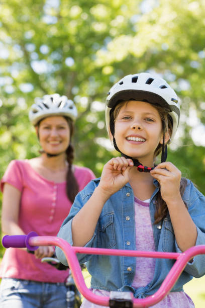 istock Smiling woman with her daughter riding a bicycle 835754004