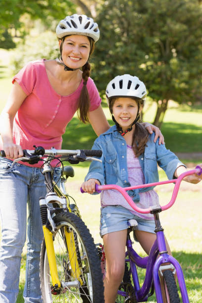 istock Woman with her daughter riding bicycles 835754098
