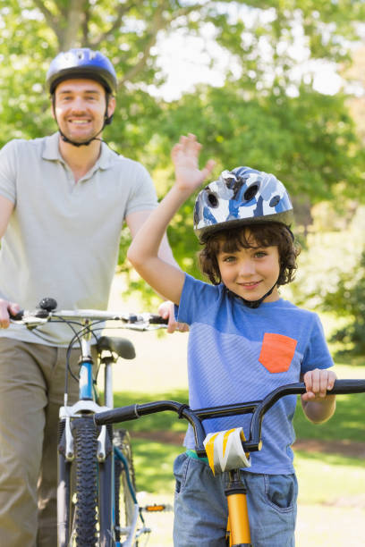 istock Smiling man with his son riding bicycles 835754180