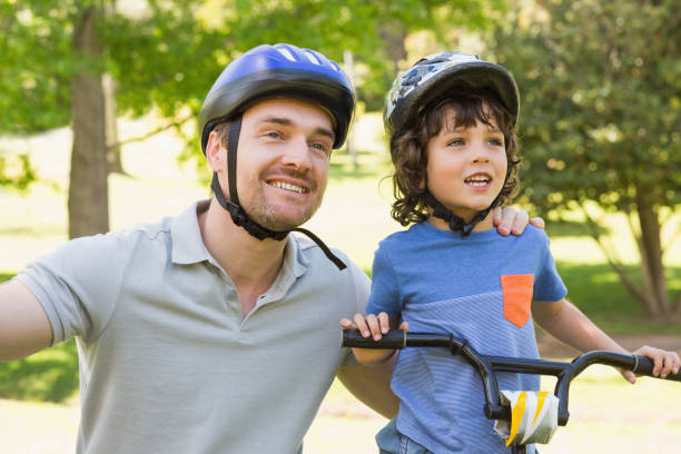 istock Smiling man with his son riding bicycle 835754192