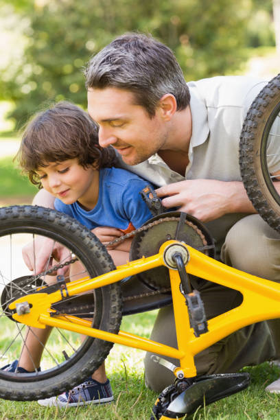 istock Father and son fixing bike 835754212