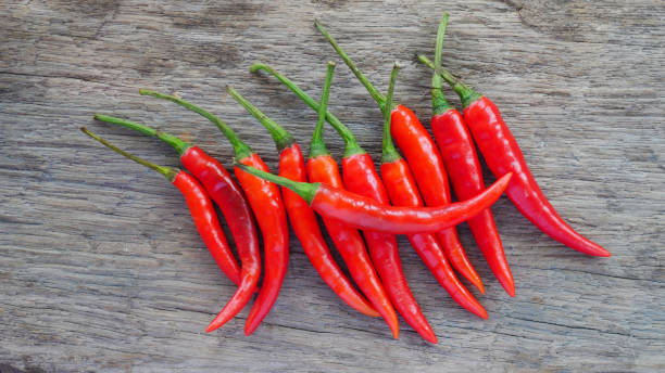 istock Fresh red chili on wood texture. 835754338
