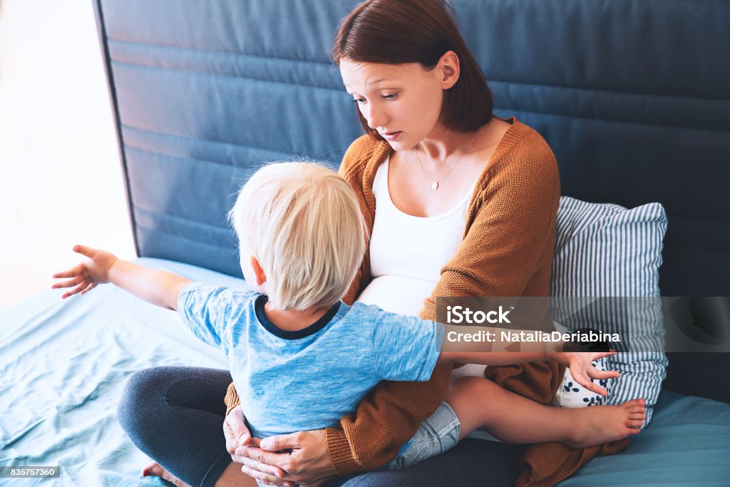Pregnant mother and son at home. Pregnant for second time with first child. Pregnant mother and son at home. Pregnant for second time with first child. Toddler boy and mom. Family in expectation of baby. Pregnancy, family, love, maternity concepts. Child Stock Photo