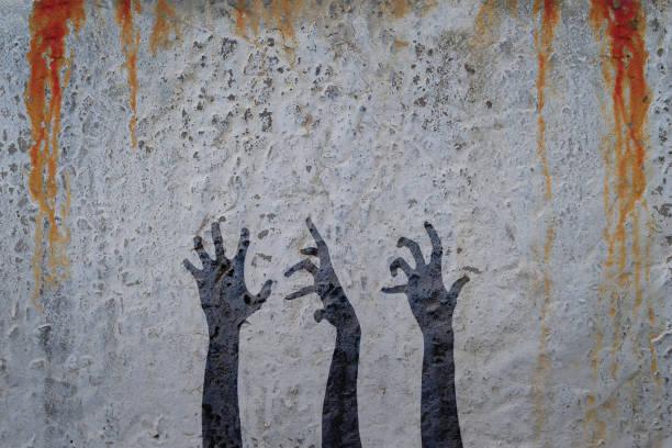 istock Zombie hands silhouette in shadow on concrete wall and blood background. 835758032