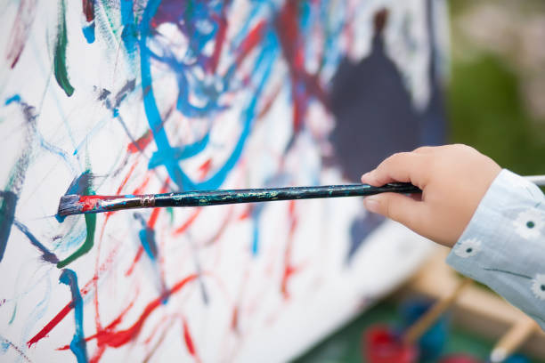 istock Closeup photo, child painting on easel 835761636