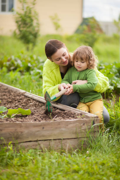 istock Mother and daughter working in the domectic garden 835764118
