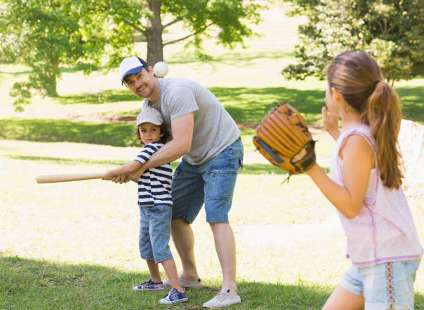 istock Family playing baseball in the park 835768010