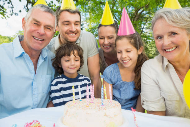istock Family with cake outdoors 835768398
