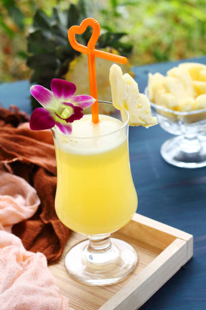 istock Pineapple juice on blue green background. 835768606