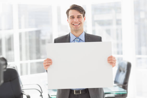 istock Handsome happy businessman holding placard 835768636