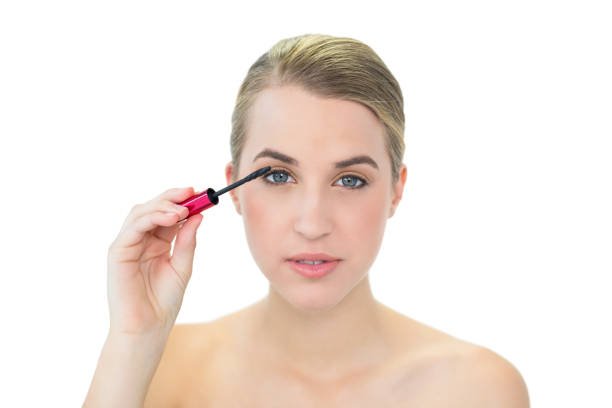 istock Smiling attractive blonde applying mascara 835768690