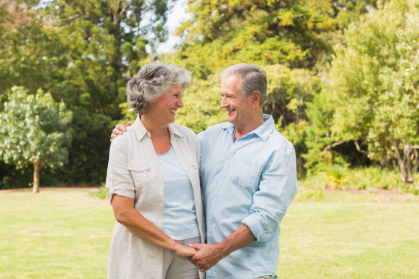 istock Smiling mature couple in park 835772472