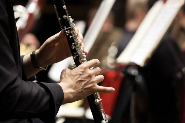 Hands of man playing the clarinet Hands of man playing the clarinet in the orchestra closeup clarinet stock pictures, royalty-free photos & images