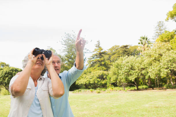istock Man showing something to his wife with binoculars 835772526