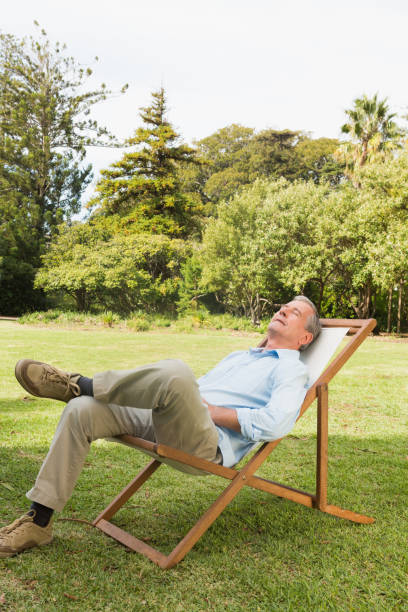 istock Happy man resting in sun lounger 835772546