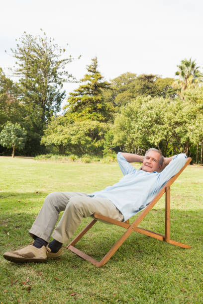 istock Happy mature man resting in sun lounger 835772548