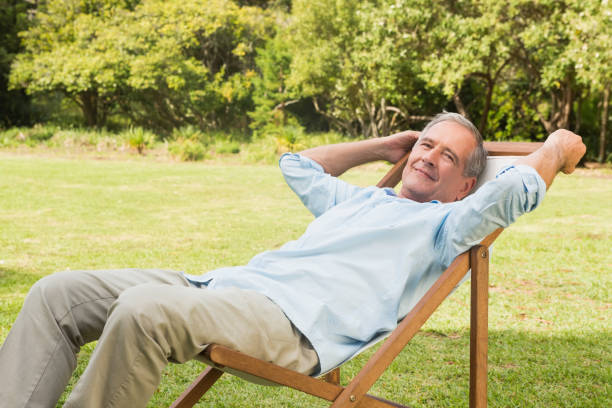 istock Happy mature man sitting on sun lounger 835772564