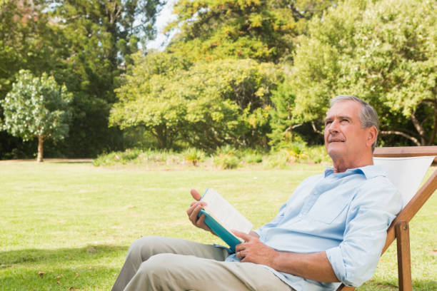 istock Smiling mature man holding a book 835772638