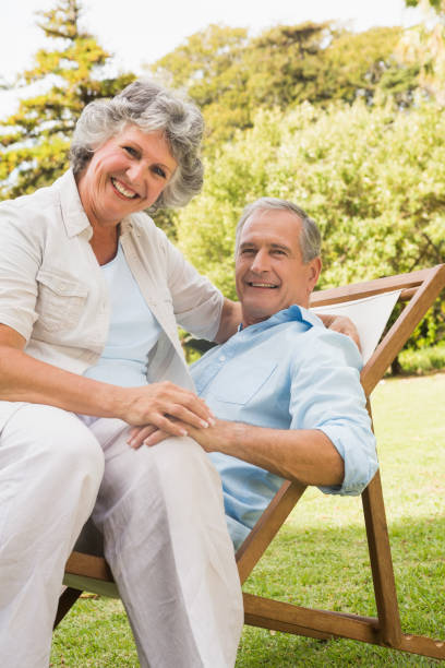 istock Smiling mature couple resting on sun lounger 835772674