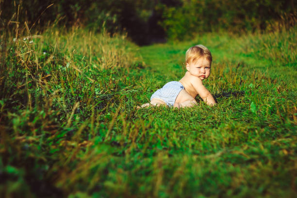 istock The child is sitting on the grass 835783618