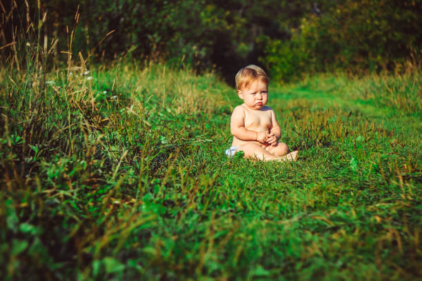 istock The child is sitting on the grass 835783634