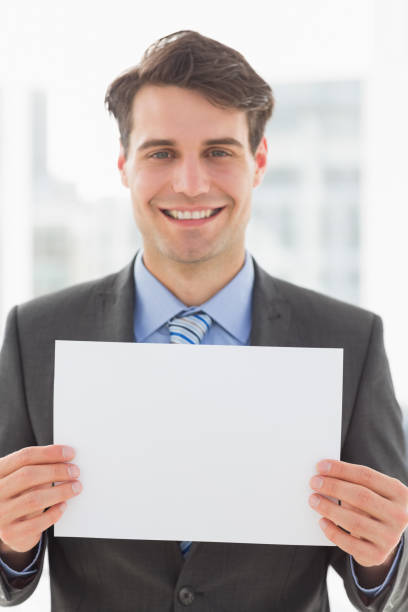 istock Happy businessman holding blank page 835784078