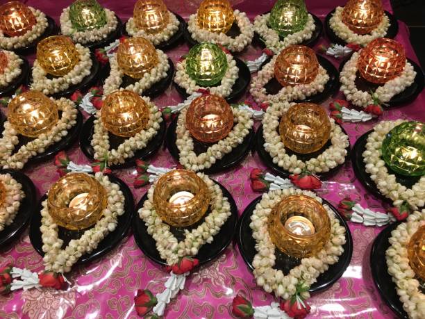 istock Candles circled with white flowers in a buddhist temple 835784312