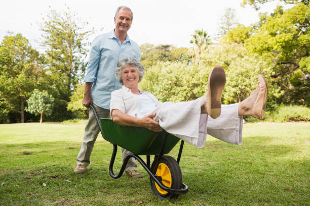 istock Cheerful man pushing his wife in a wheelbarrow 835791146