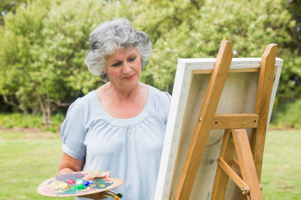 istock Content mature woman painting on canvas 835791304