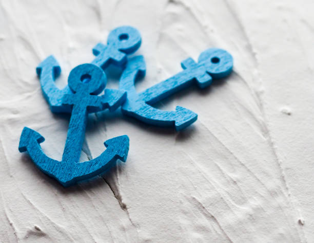 istock Background with decorative anchors and wheels on a white painted background. Place for text. Top view with copy space 835795542