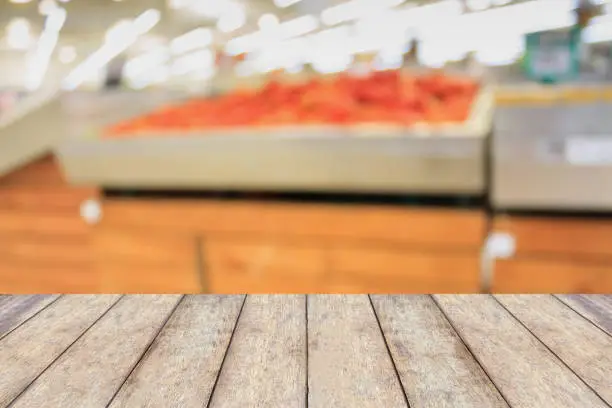 Photo of Empty wood table top with Supermarket blurred background