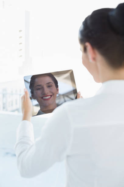 istock Business woman looking at her reflection in tablet PC 835802360