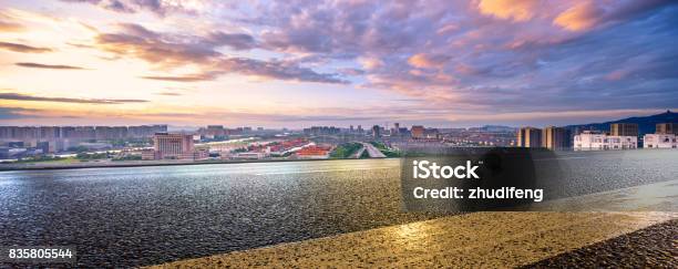 Empty Road And Cityscape Of Modern City Against Cloud Sky Stock Photo - Download Image Now