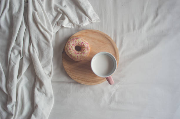 istock Donut and pink mug in bed 835807188