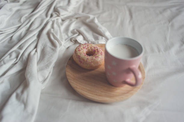 istock Donut and pink mug in bed 835807336