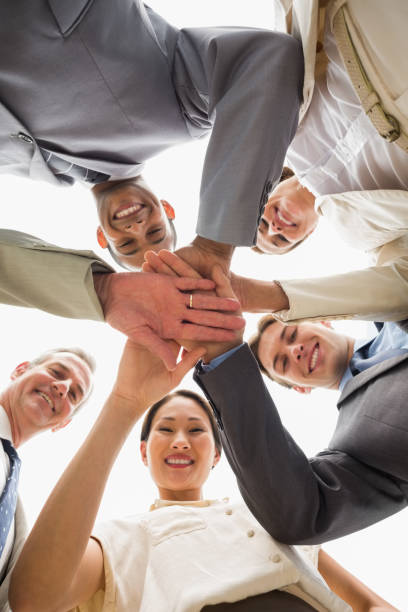 istock Happy business team looking down at the camera with hands together 835810278