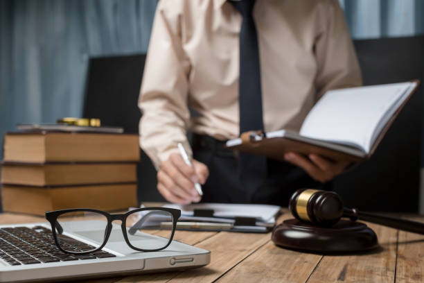 istock Business lawyer working hard at office desk workplace with book and documents. 835813402