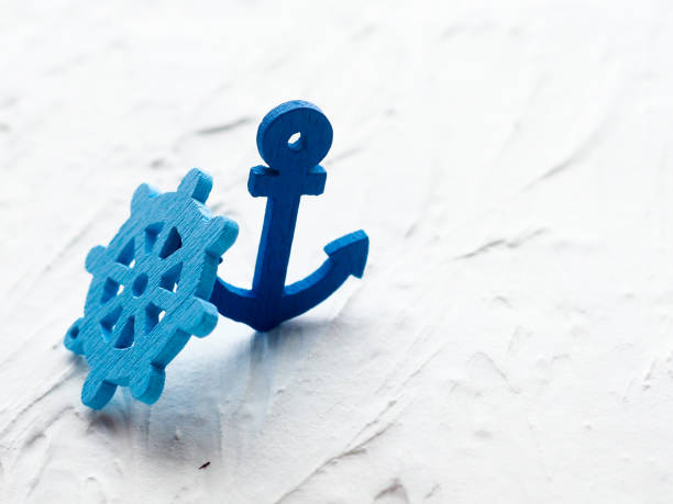 istock Background with decorative anchors and wheels on a white painted background. Place for text. Top view with copy space 835813766
