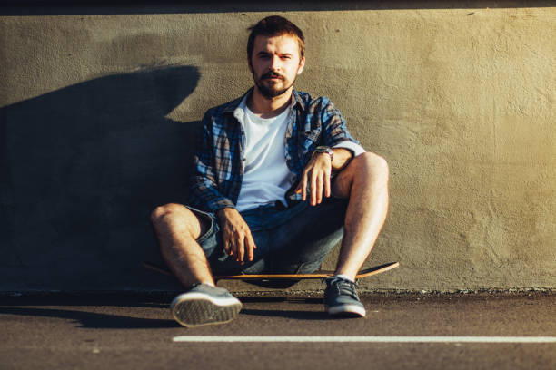 istock Hipster is sitting on a skateboard 835820134