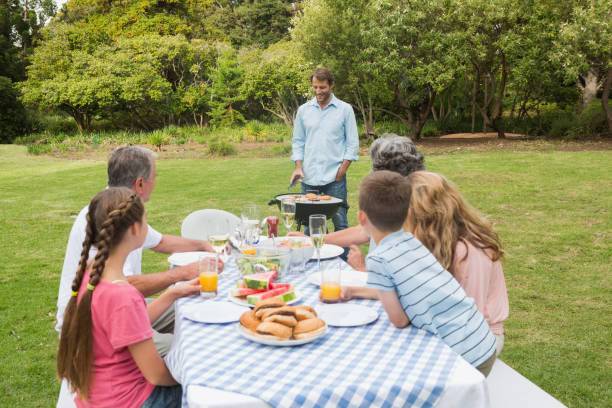 istock Cheerful extended family watching father at the barbecue 835821224