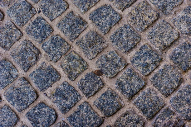 istock Geometry pattern of cobblestone background traditional stone paving 835821738