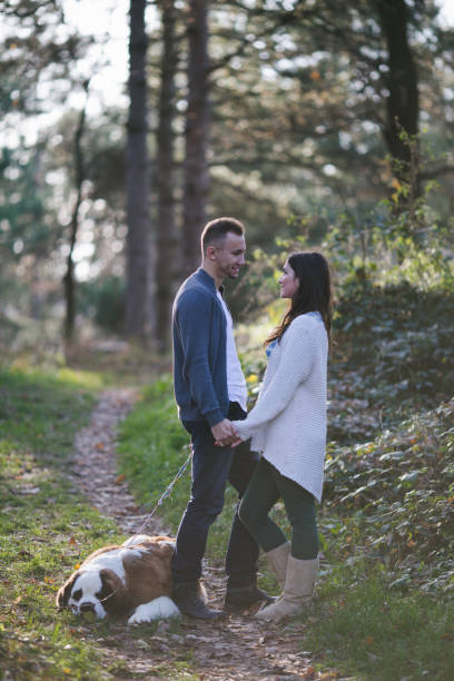 istock Couple and dog in park 835822264