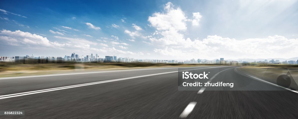 empty road and cityscape of modern city against cloud sky blurred empty asphalt road with cityscape of hangzhou in cloud sky Architecture Stock Photo