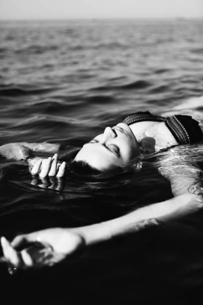 istock Woman floating on water 835829606