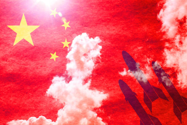 Missiles in front of sunny chinese flag Chinese flag shining through a sunny blue sky background and 3 missiles starting from the right military attack photos stock pictures, royalty-free photos & images
