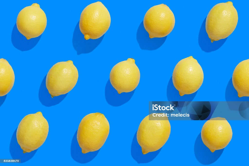 Fresh lemons on a saturated blue background Citrus Fruit, Food, Food and Drink, Fruit, Lemon - Fruit, infinity, seamless pattern Lemon - Fruit Stock Photo